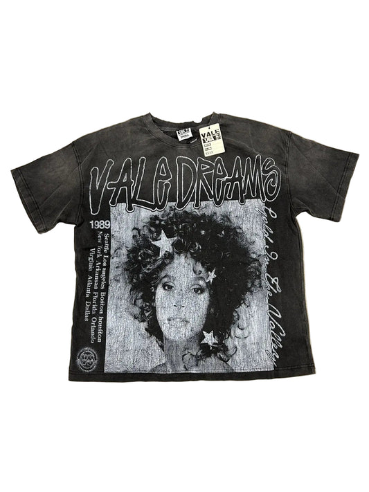 Black t-shirt with graphic design and text on a beige surf